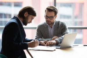 A worker discussing their options for suing their employer with an employment lawyer.