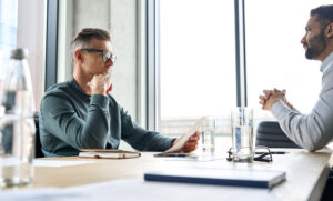 An employment lawyer explaining the process of filing a lawsuit against an employer to a client.