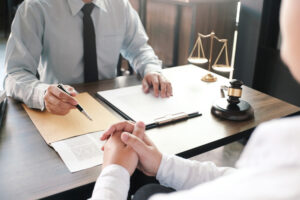 Lawyer sits across desk from client and explains how to prove workplace discrimination