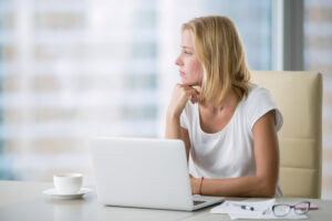 A woman reviewing the difference between disparate treatment and disparate impact.