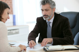 A lawyer sits across from a client and explains Massachusetts’ whistleblower laws and protections.