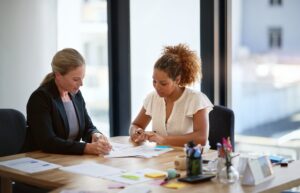 An employment lawyer explains to a client that you can sue for breach of an employment contract.