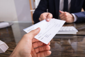 A salaried employee in Rhode Island receives a paycheck. A labor and employment lawyer can review the state's labor laws for salaried workers.