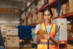 A warehouse employee receives her overtime pay. If Amazon has not paid you for the overtime you worked, consult an employment attorney who can file a complaint and take legal action to recover your wages