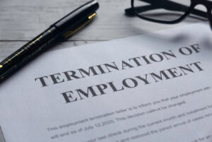 A termination of employment letter sits on desk. If you believe Costco fired you unfairly, you can consult a labor and employment attorney who can take legal action for you.